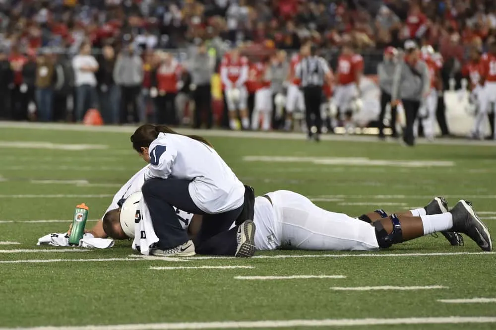 Trainers tends to an injured Nittany Lion player during the NCAA football game