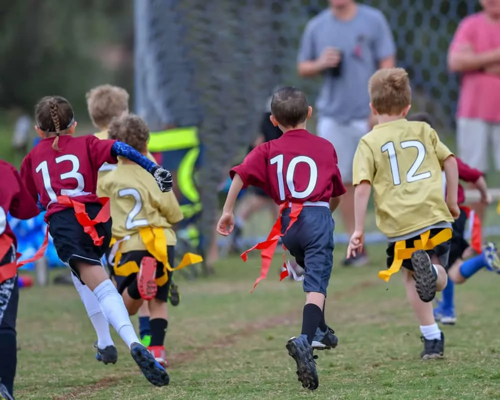 Children playing a Flag Football game outside