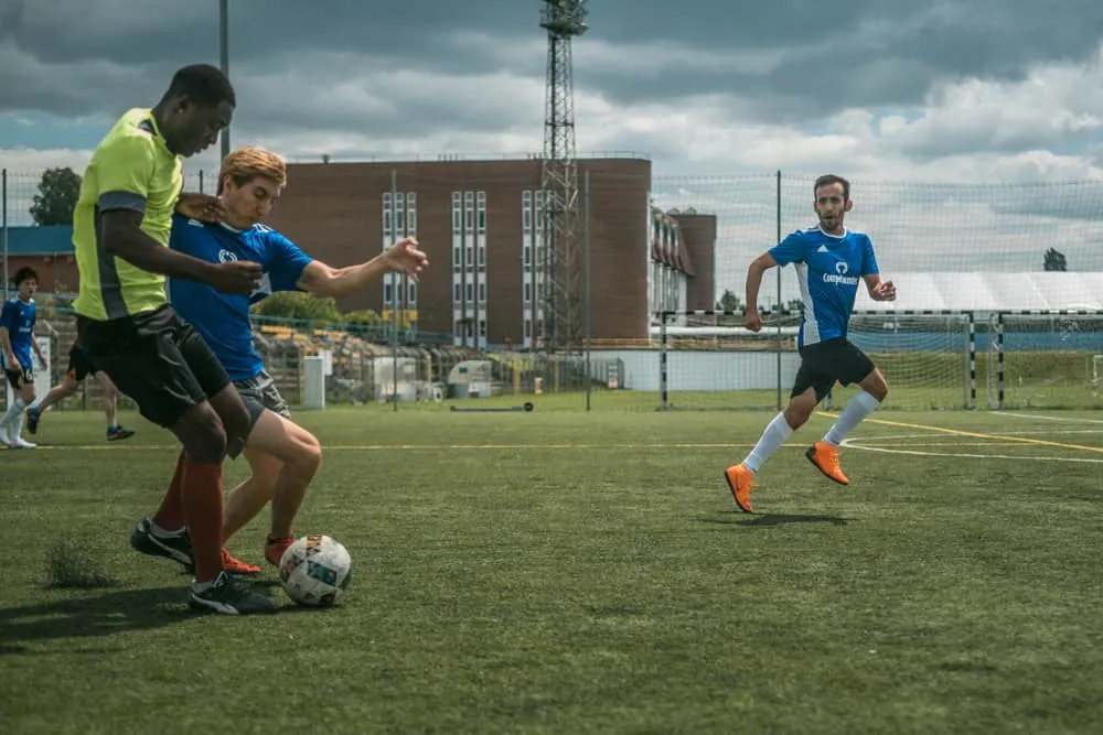 Close up of a football action scene with competing soccer players