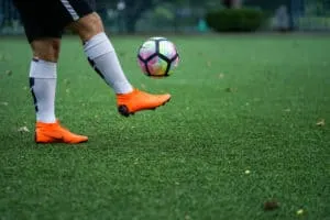 Football player training on artificial grass field