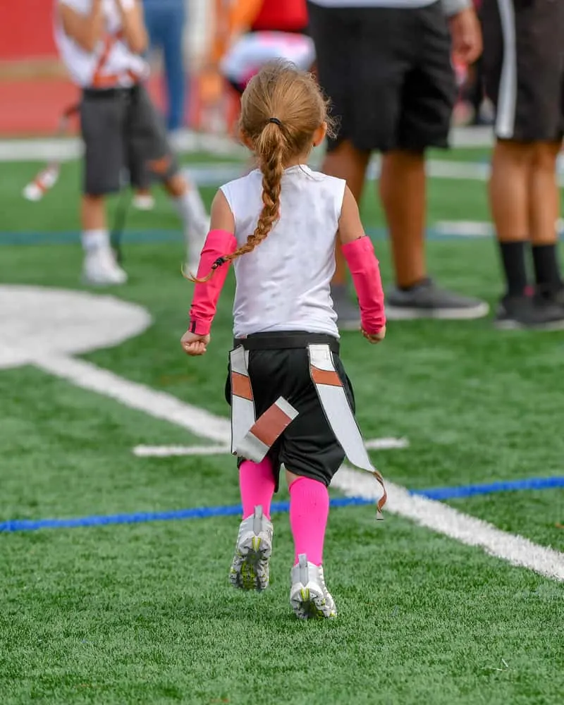 Little girl playing flag football