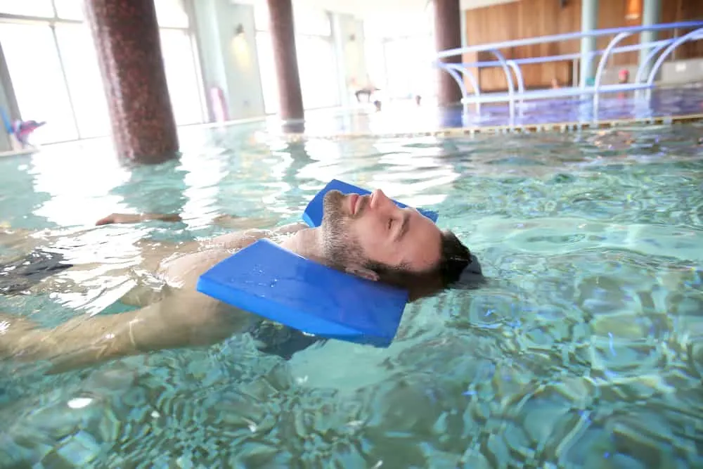 Man in spa pool doing exercises for muscular recovery