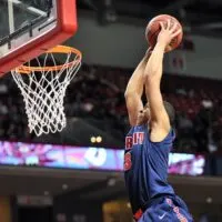 Ray McCallum flies in to slam the ball for a dunk during the basketball game