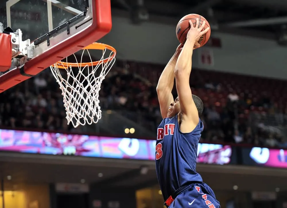 Ray McCallum flies in to slam the ball for a dunk during the basketball game