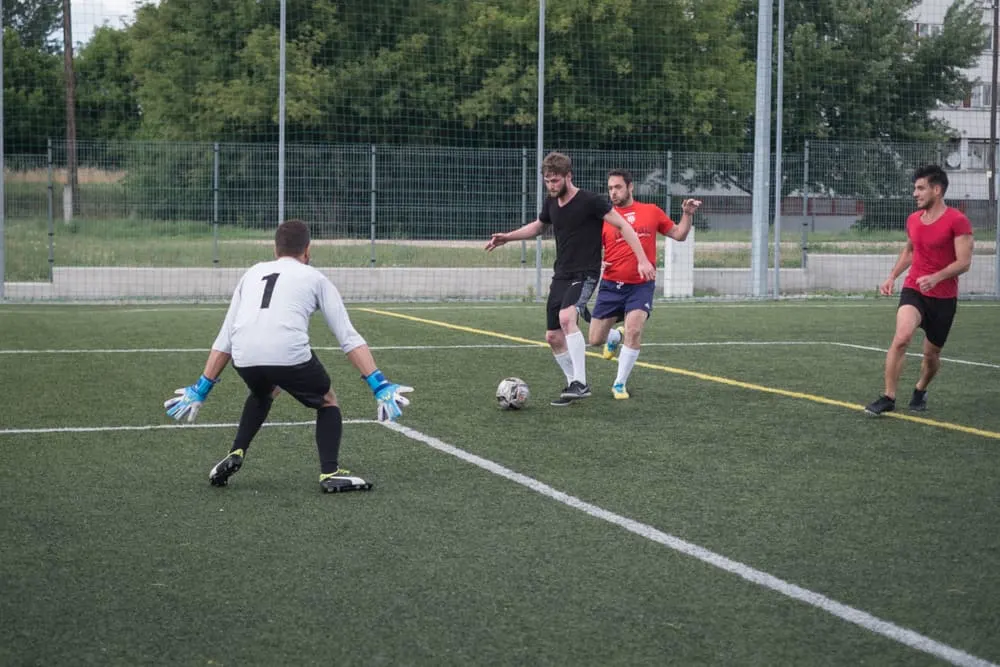 goal keeper trying to parry the ball in a soccer tryouts