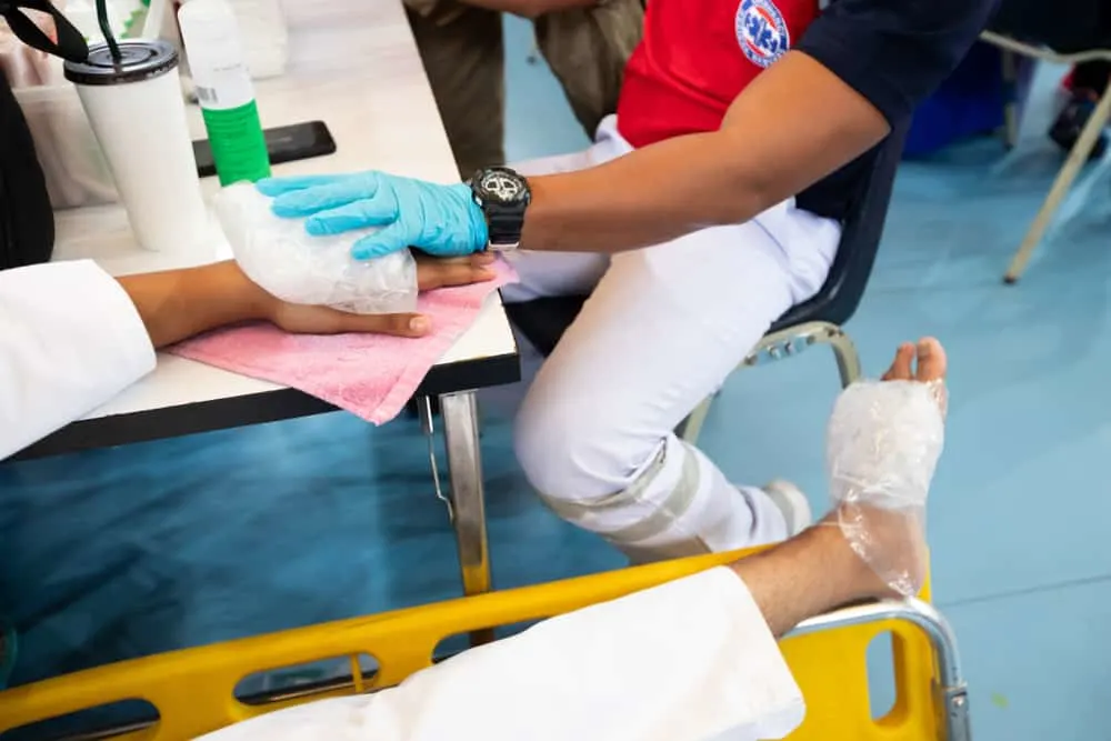 Ice pack on hand and foot of injured player taekwondo